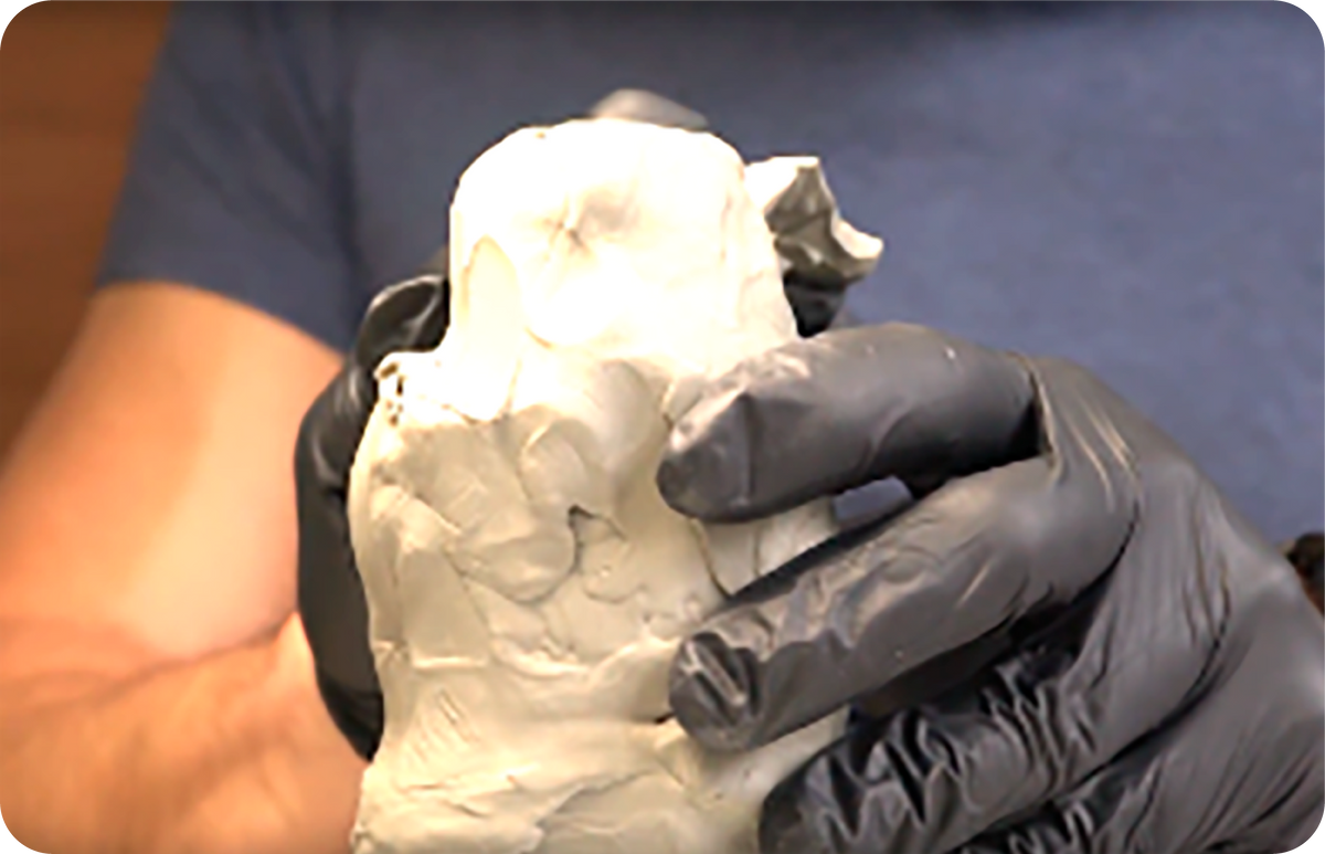 Artisan sculpting the original ornament design in clay
