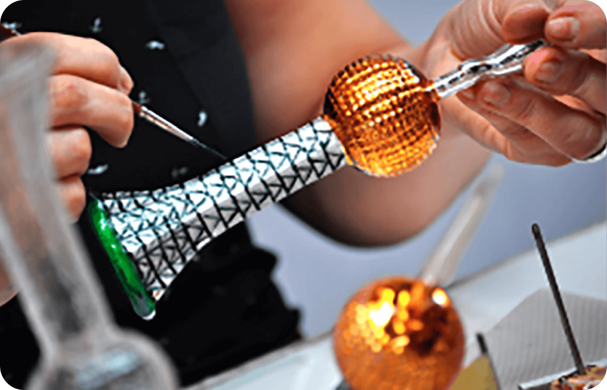 Artisan hand-painting details on the glass ornament